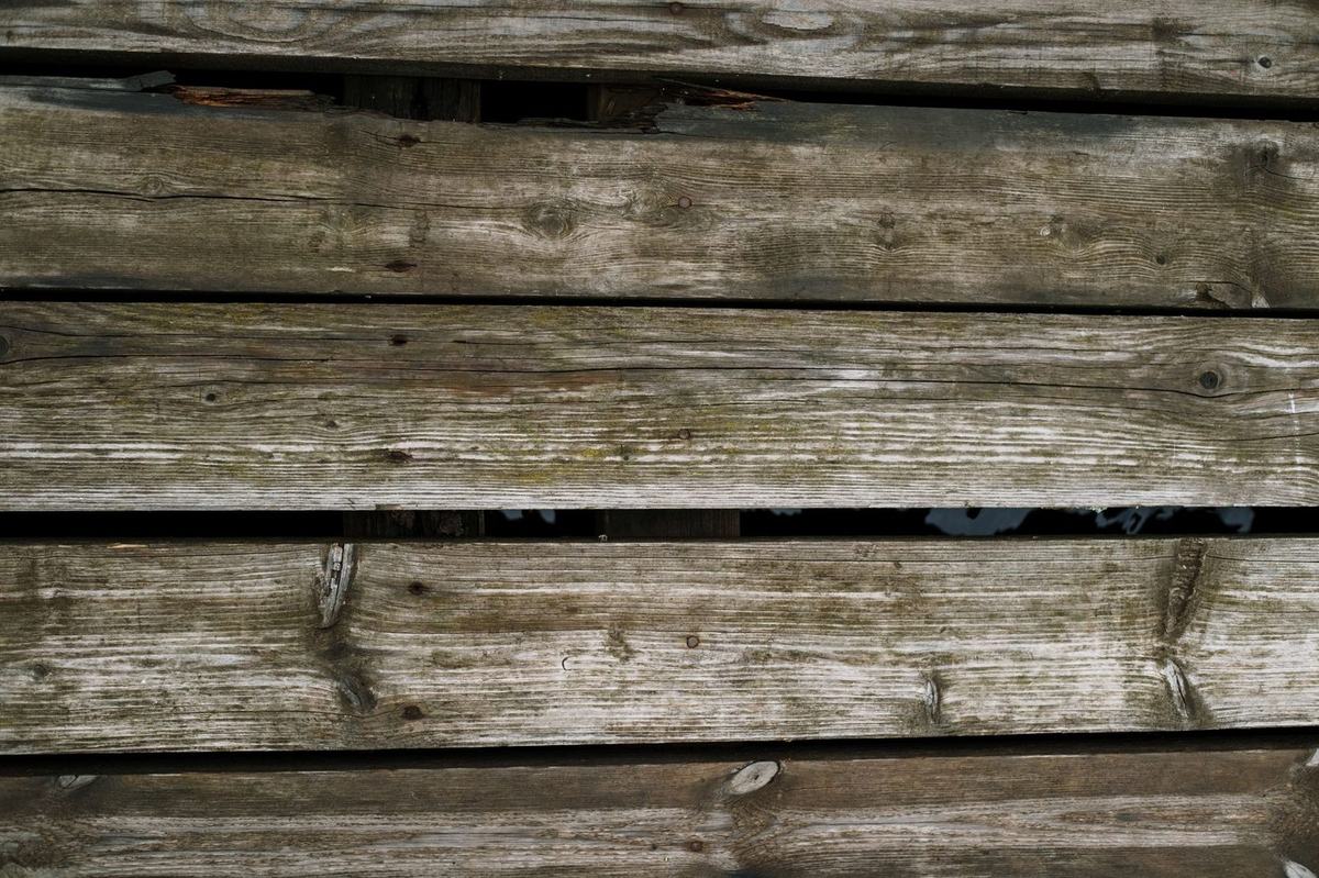 Weathered and broken decking boards needing repair
